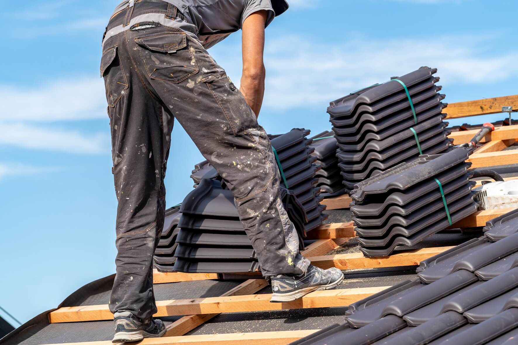 Roofer installing shingles